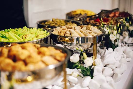 Guests being served at an elegant buffet